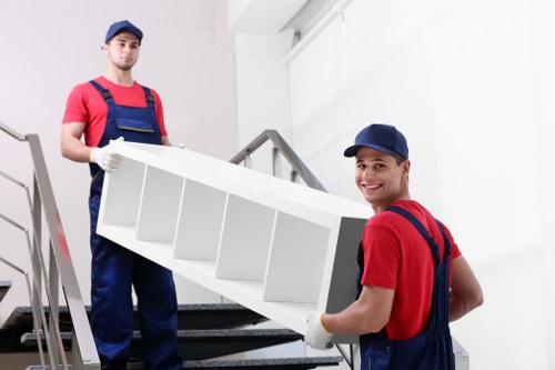 Professional movers handling furniture in a removal van.