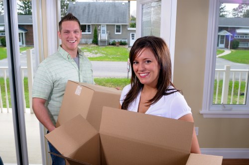 Professional movers handling household items during removal